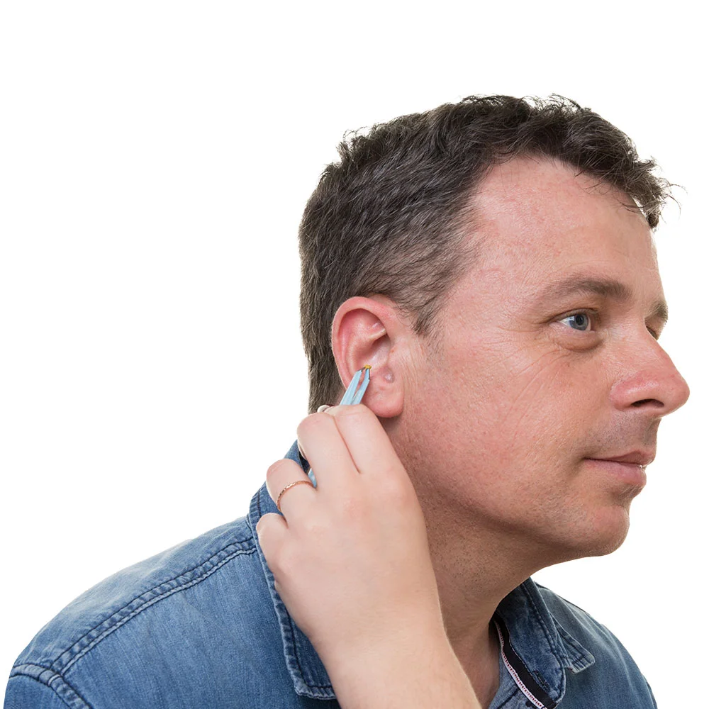 Patient undergoing manual earwax removal