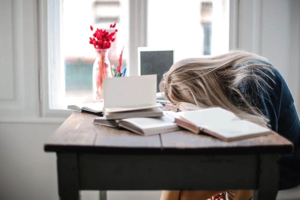 Tired employee asleep on desk
